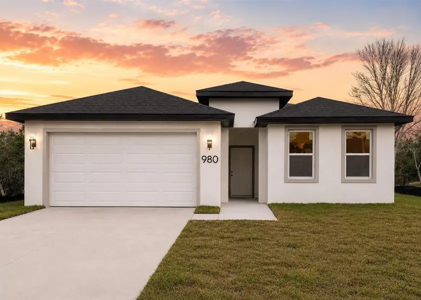 Front exterior of a new home in , Palm Bay, FL, highlighting curb appeal (Image 1). Front exterior of a new home in , Palm Bay, FL, highlighting curb appeal (Image 1).