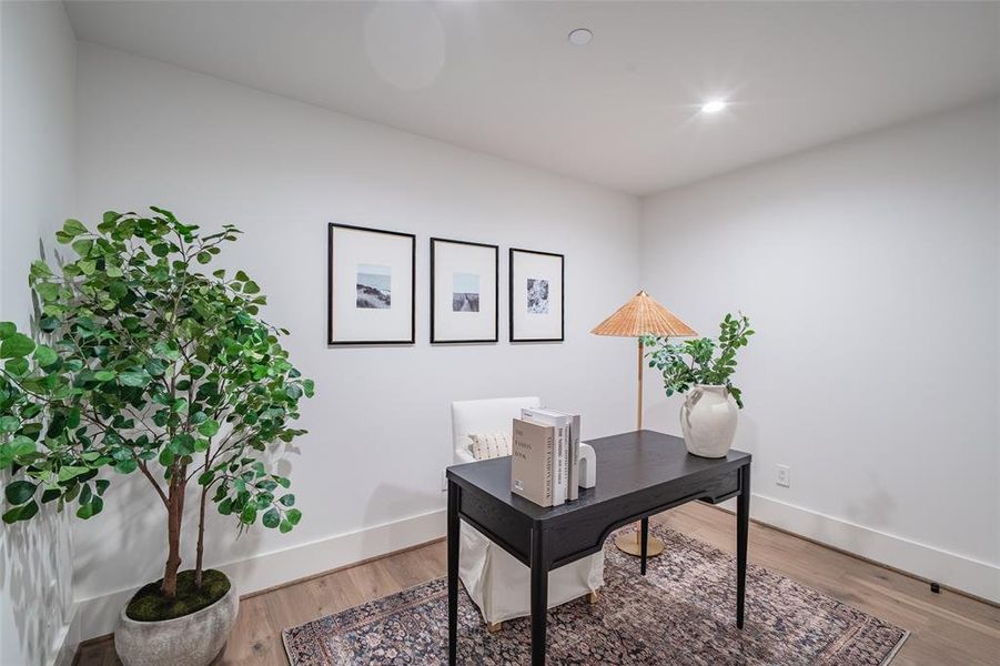 Office with hardwood / wood-style flooring