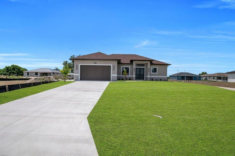 Front exterior of a new home in , Lehigh Acres, FL, highlighting curb appeal (Image 22).
