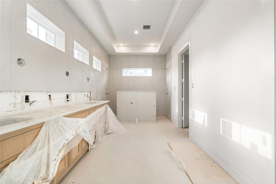 Primary bath with double vanity, double showerhead, and soaker tub. Primary bath with double vanity, double showerhead, and soaker tub.