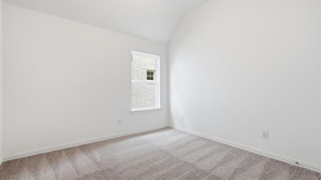 Interior room featuring light-colored carpeting, white wall paint, and white baseboards Interior room featuring light-colored carpeting, white wall paint, and white baseboards