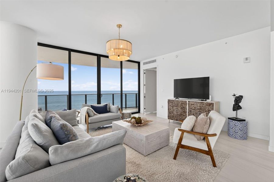 Light filled open living area with floor to ceiling glass and seamless indoor outdoor flow to expansive terrace.