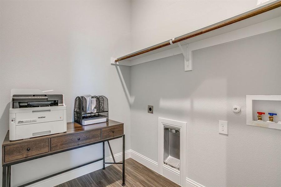 Laundry area featuring wood finished floors, hookup for a washing machine, hookup for a gas dryer, and electric dryer hookup