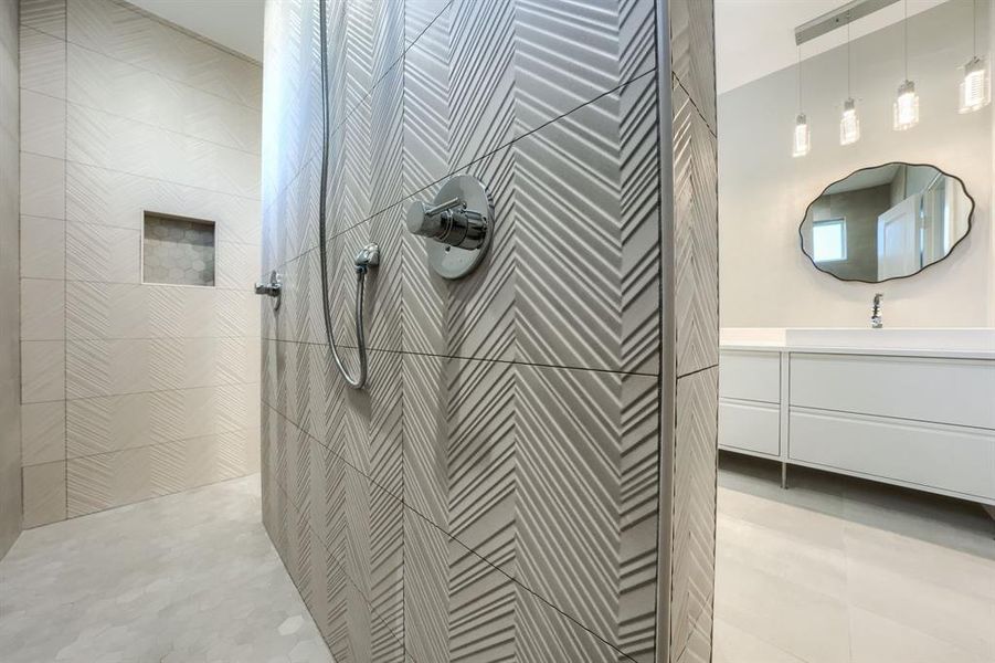 Bathroom with a tile shower and vanity