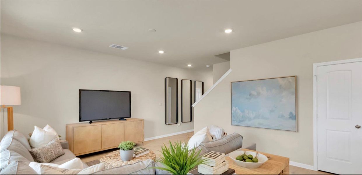 Living area with recessed lighting and baseboards