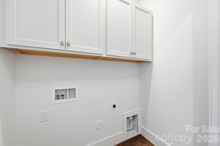 Laundry Closet with added upper cabinets for extra storage.