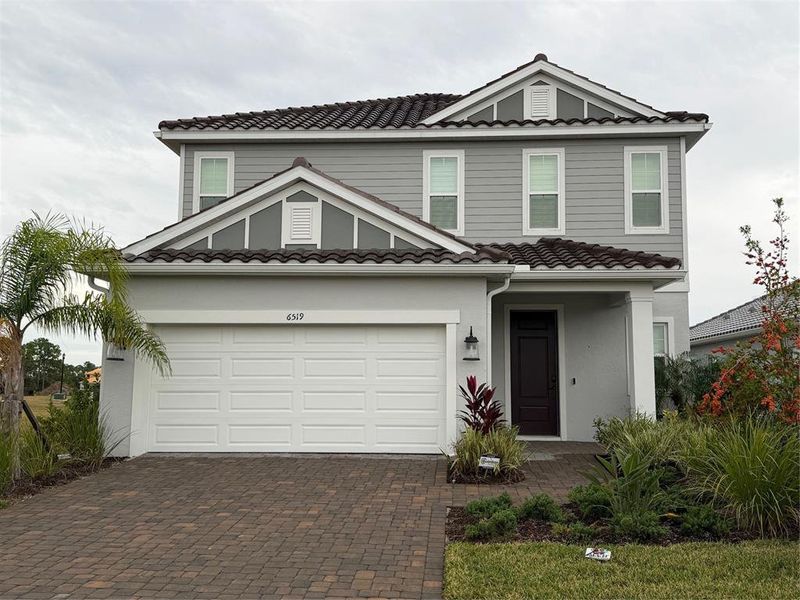 Front exterior of a new home in , Sarasota, FL, highlighting curb appeal (Image 32). Front exterior of a new home in , Sarasota, FL, highlighting curb appeal (Image 32).