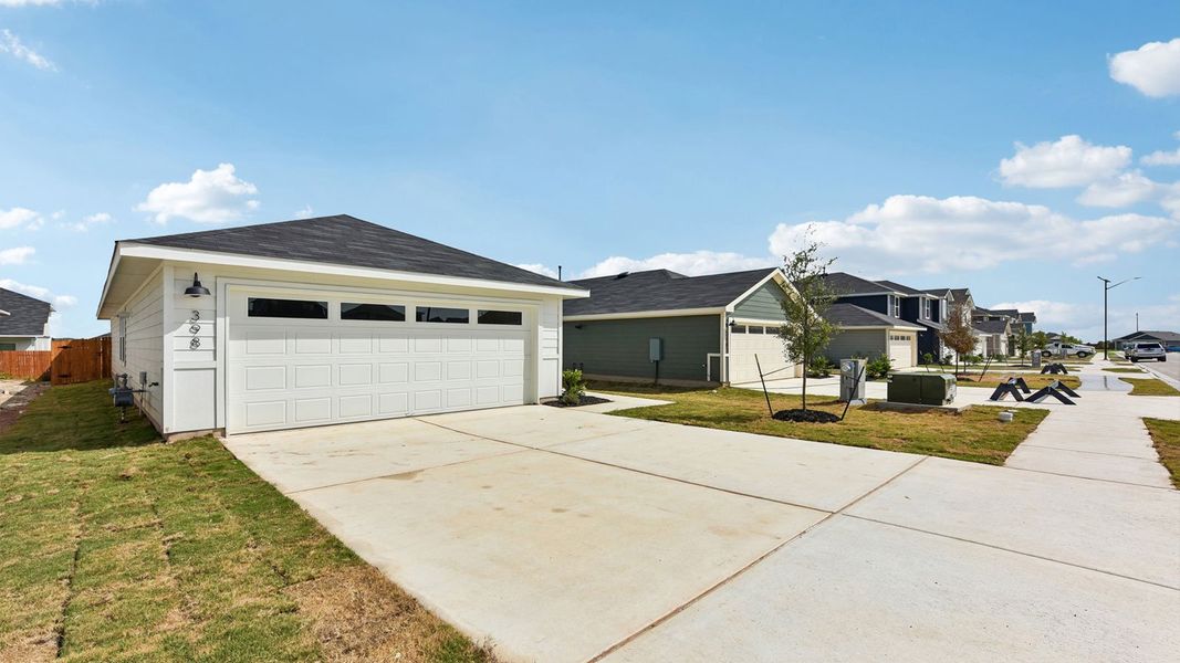 Front exterior of a new home in Watermill, Uhland, TX, highlighting curb appeal (Image 20). Front exterior of a new home in Watermill, Uhland, TX, highlighting curb appeal (Image 20).