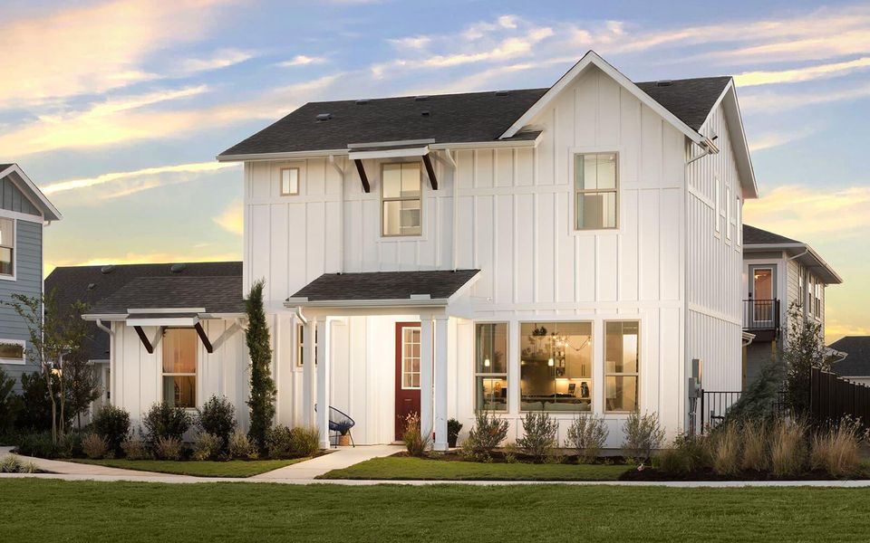 View of front facade featuring board and batten siding and a front yard View of front facade featuring board and batten siding and a front yard