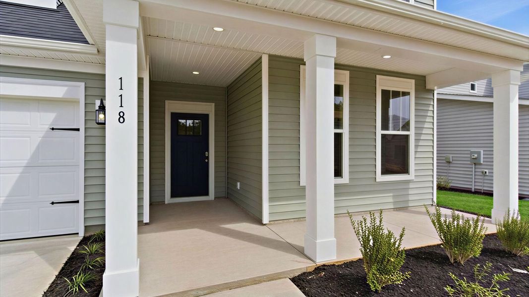 Stylish front elevation with a covered front porch and accomplished design throughout at this home in Gray Court, SC