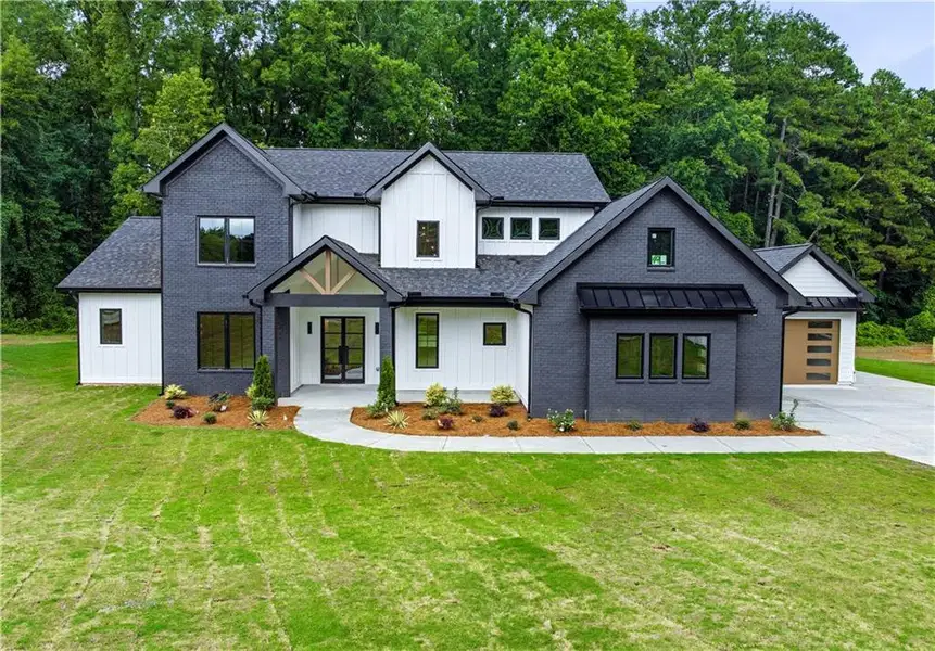Front exterior of a new home in , Cumming, GA, highlighting curb appeal (Image 1). Front exterior of a new home in , Cumming, GA, highlighting curb appeal (Image 1).