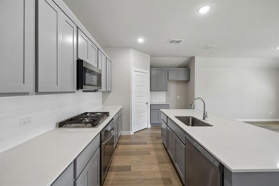 Kitchen in the Emmy II home plan by Trophy Signature Homes - REPRESENTATIVE PHOTO