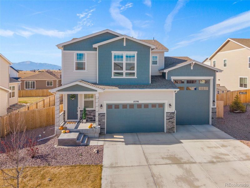 Front exterior of a new home in Paint Brush Hills, Peyton, CO, highlighting curb appeal (Image 28).