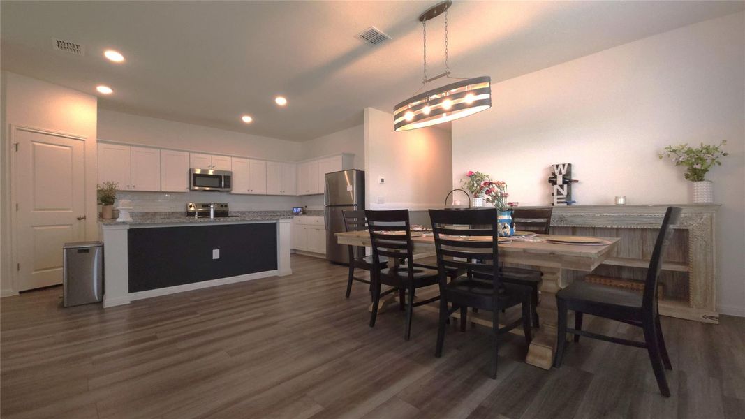 Open-concept living space featuring wood-finish flooring