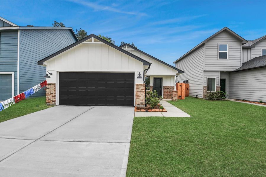 Front exterior of a new home in The Enclave at Spring Branch, Montgomery, TX, highlighting curb appeal (Image 22). Front exterior of a new home in The Enclave at Spring Branch, Montgomery, TX, highlighting curb appeal (Image 22).