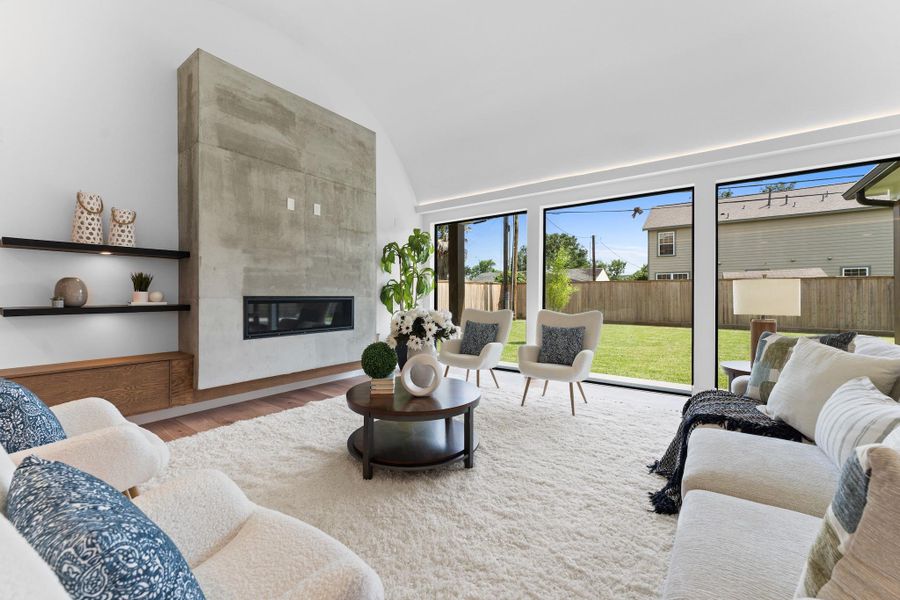 Walls of windows invite the outdoors in, while layered design textures ground the space with understated luxury.