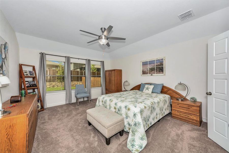 Bedroom with ceiling fan and carpet floors