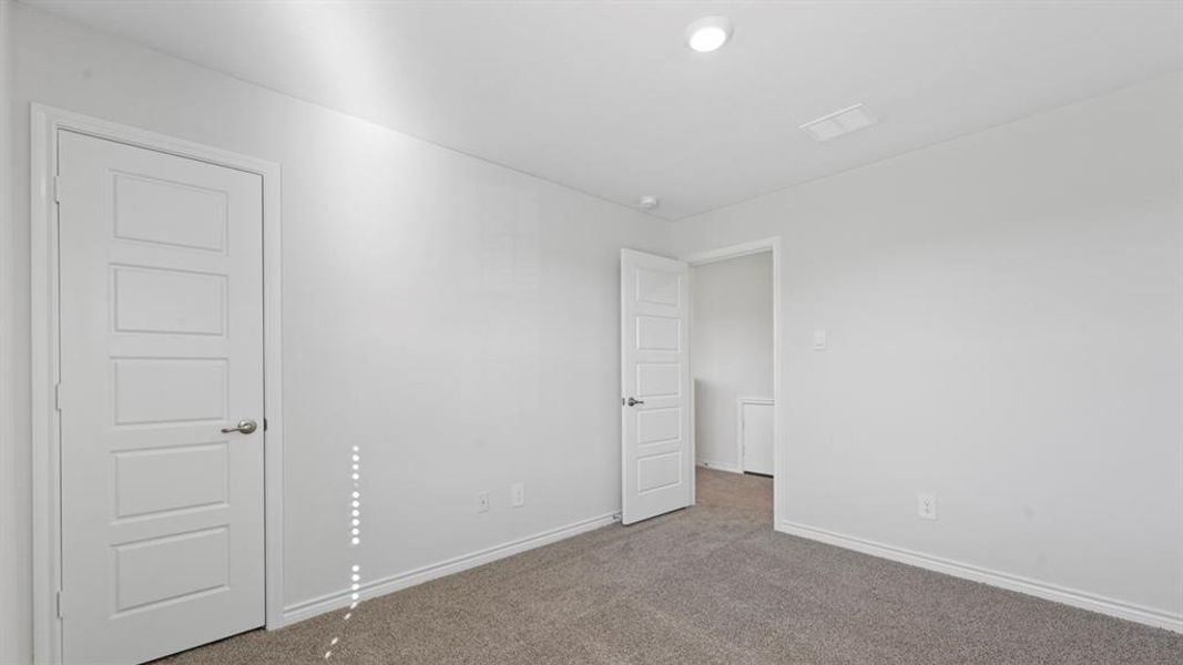 Unfurnished bedroom with carpet floors and baseboards Unfurnished bedroom with carpet floors and baseboards
