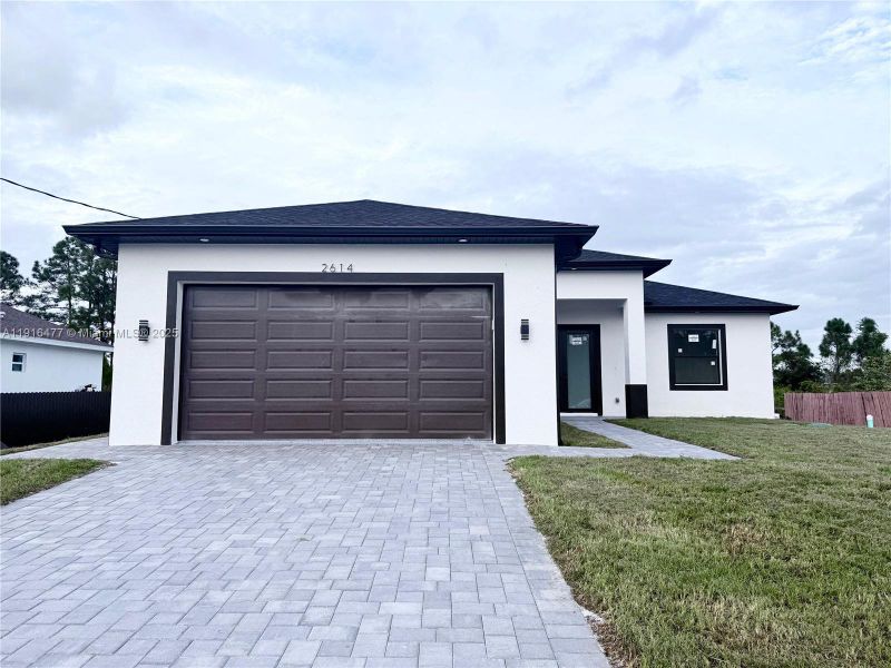 Front exterior of a new home in , Lehigh Acres, FL, highlighting curb appeal (Image 2). Front exterior of a new home in , Lehigh Acres, FL, highlighting curb appeal (Image 2).