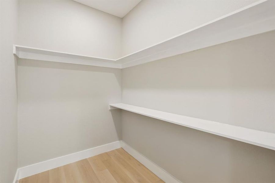 Interior storage space with light wood-finish flooring Interior storage space with light wood-finish flooring