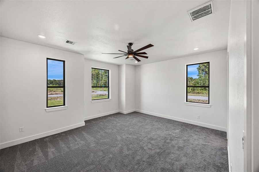 Master suite with high ceiling, recessed light, natural light and en suite bathroom.