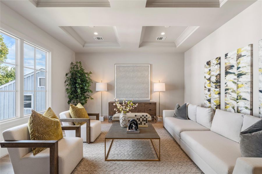 The huge walls of the media room will house a flatscreen or projector with ease. Windows bring in the perfect amount of light; curtains or shutters will help create an ambient theater experience.