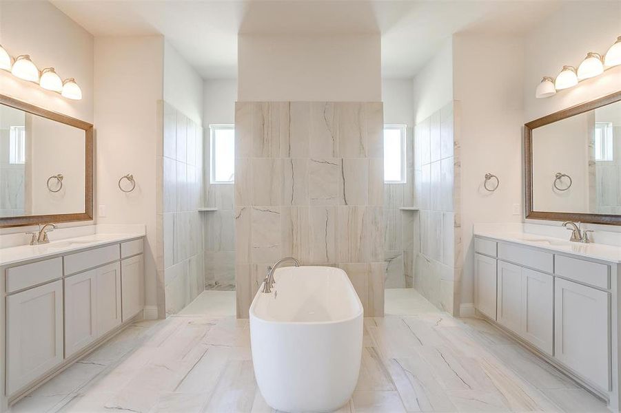 Bathroom with vanity, tile patterned floors, and a healthy amount of sunlight