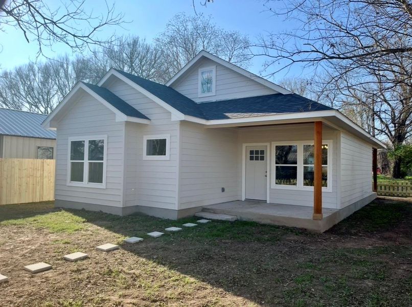 View of front of home with roof with shingles