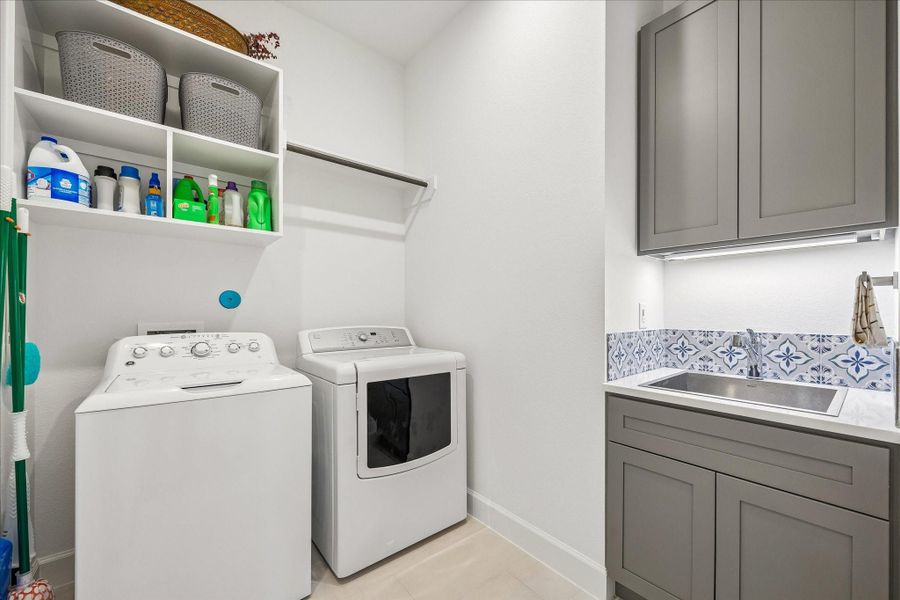 Large laundry room with extra storage and sink