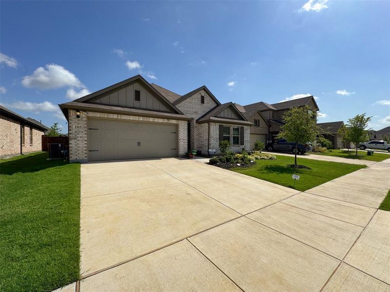 Front exterior of a new home in Woodmere, Denton, TX, highlighting curb appeal (Image 16). Front exterior of a new home in Woodmere, Denton, TX, highlighting curb appeal (Image 16).