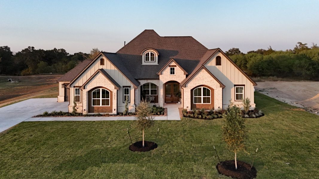 Front exterior of a new home in Windmill Hill, Bryan, TX, highlighting curb appeal (Image 32).