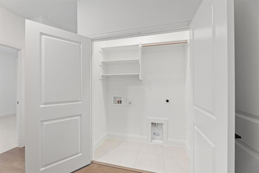 Laundry room featuring washer hookup, electric dryer hookup, and hookup for a gas dryer Laundry room featuring washer hookup, electric dryer hookup, and hookup for a gas dryer