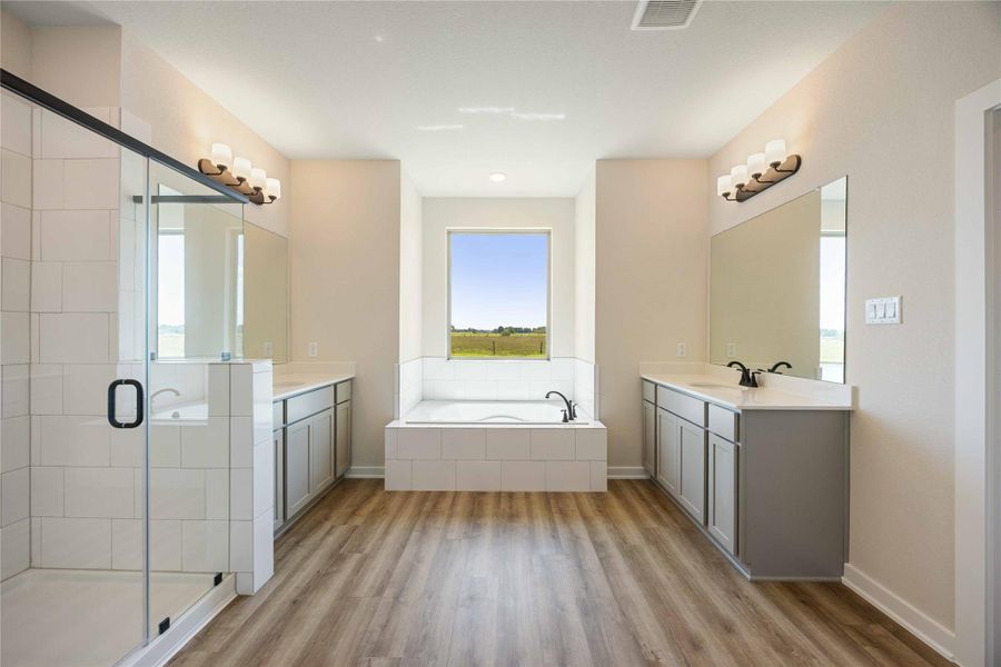 The luxurious owner's retreat is a private oasis with a spa-inspired bath and an extended walk-in closet.