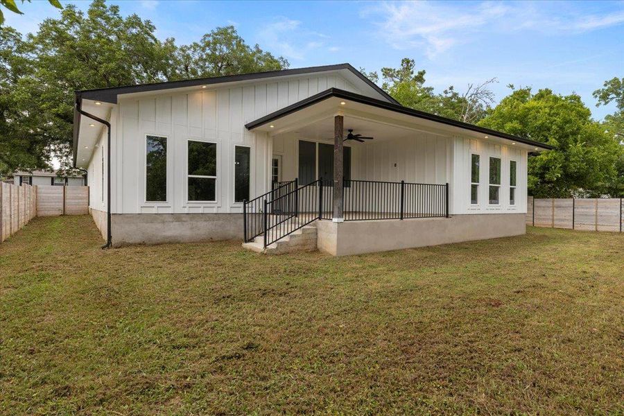 Back of property featuring a ceiling fan, a fenced backyard, and board and batten siding Back of property featuring a ceiling fan, a fenced backyard, and board and batten siding