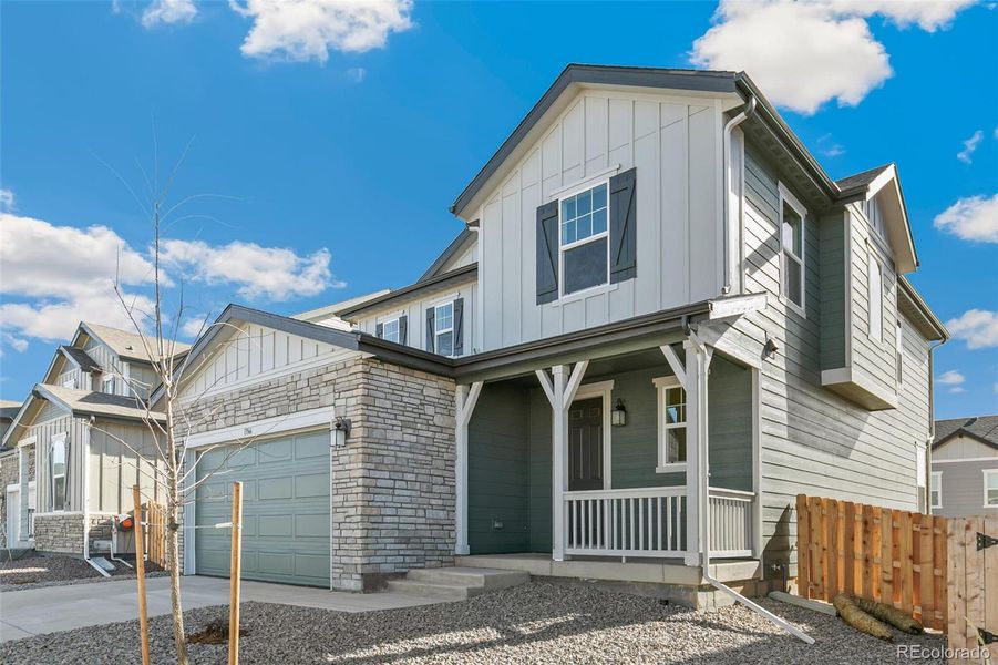 Front exterior of a new home in Turnberry, Commerce City, CO, highlighting curb appeal (Image 23).