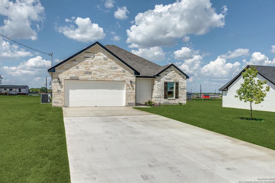 Front exterior of a new home in , Atascosa, TX, highlighting curb appeal (Image 24).