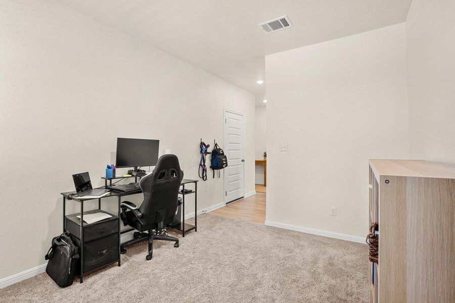 An adaptable interior space featuring plush carpeting and a versatile layout.
