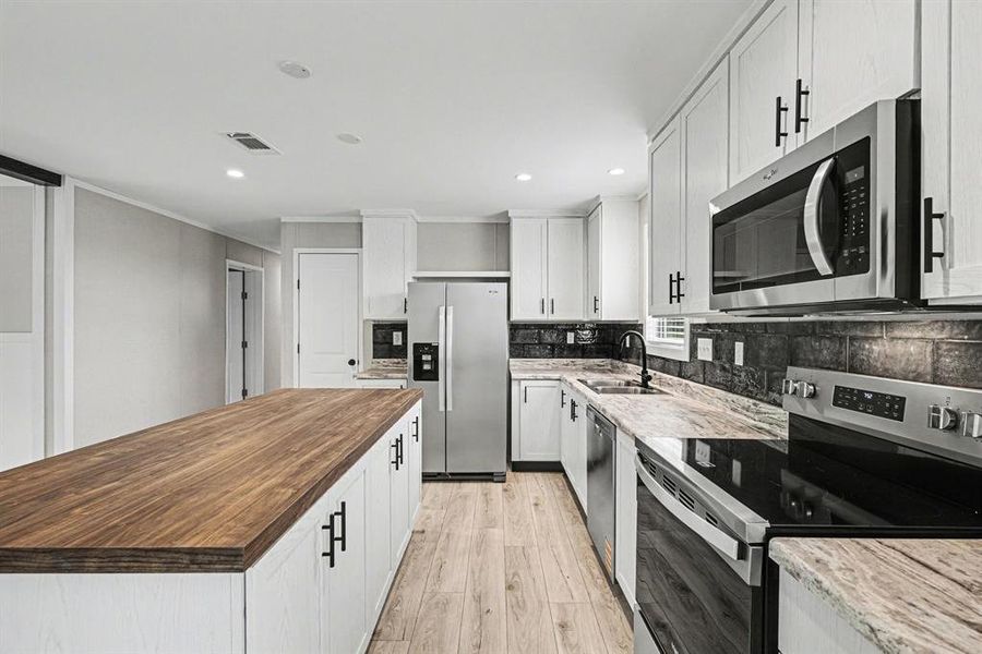 Spacious kitchen with ample storage, countertops and large pantry.