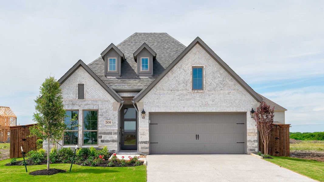 Front exterior of a new home in Meraki, Forney, TX, highlighting curb appeal (Image 1). Front exterior of a new home in Meraki, Forney, TX, highlighting curb appeal (Image 1).
