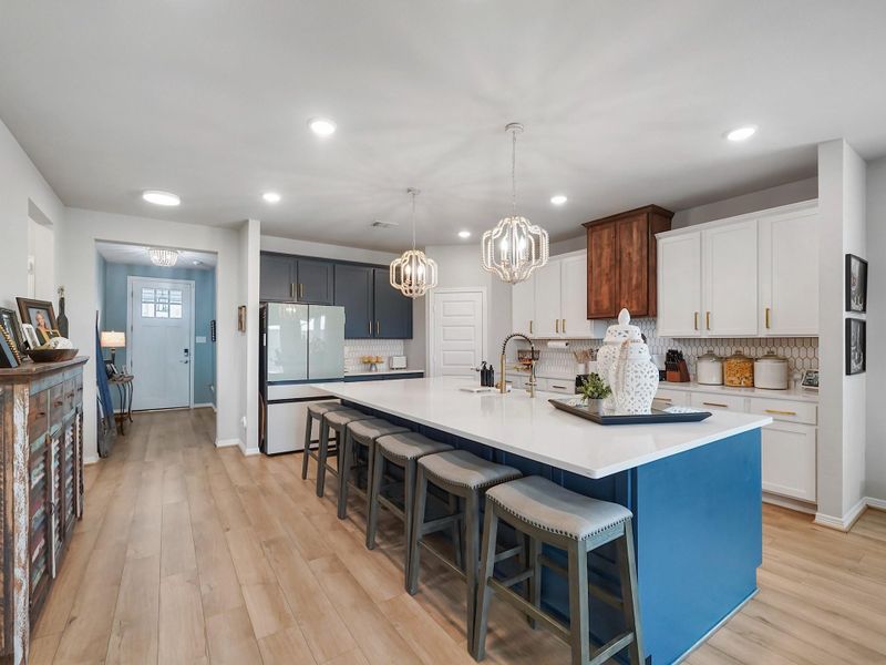 An custom oversized island anchors the space, offering ample prep area, seating, and a natural focal point for both casual meals and entertaining.  The island has storage cabinets in the front as well!