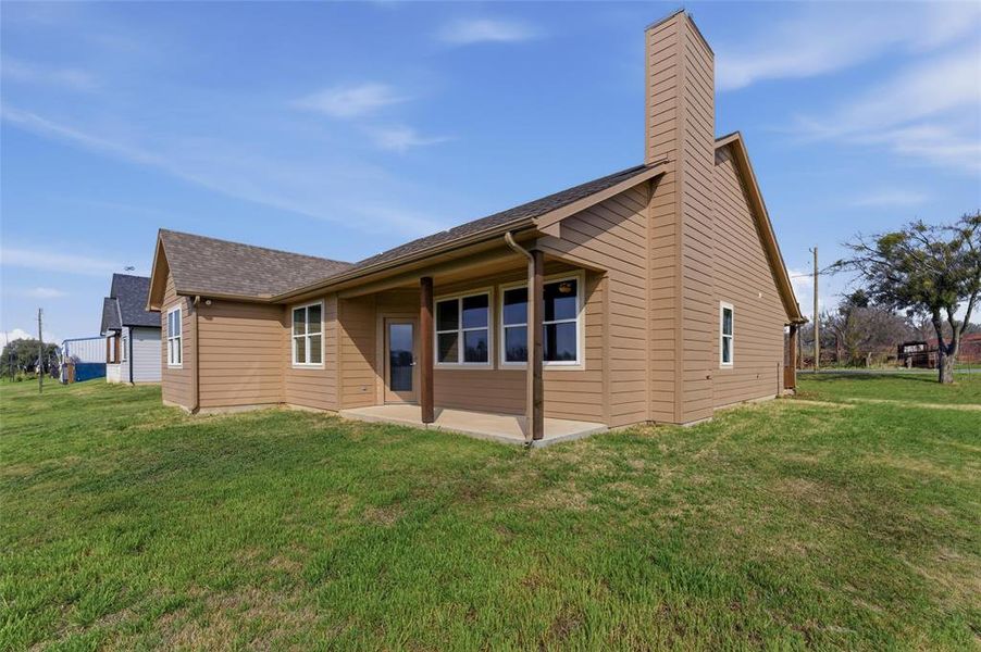 Angled view of the backyard and rear exterior. Angled view of the backyard and rear exterior.