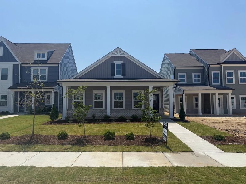 Front exterior of a new home in The Point, Rolesville, NC, highlighting curb appeal (Image 1). Front exterior of a new home in The Point, Rolesville, NC, highlighting curb appeal (Image 1).