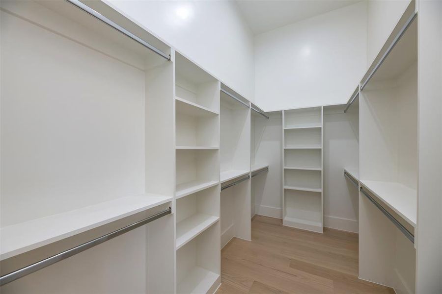 Spacious closet with light wood finished floors Spacious closet with light wood finished floors
