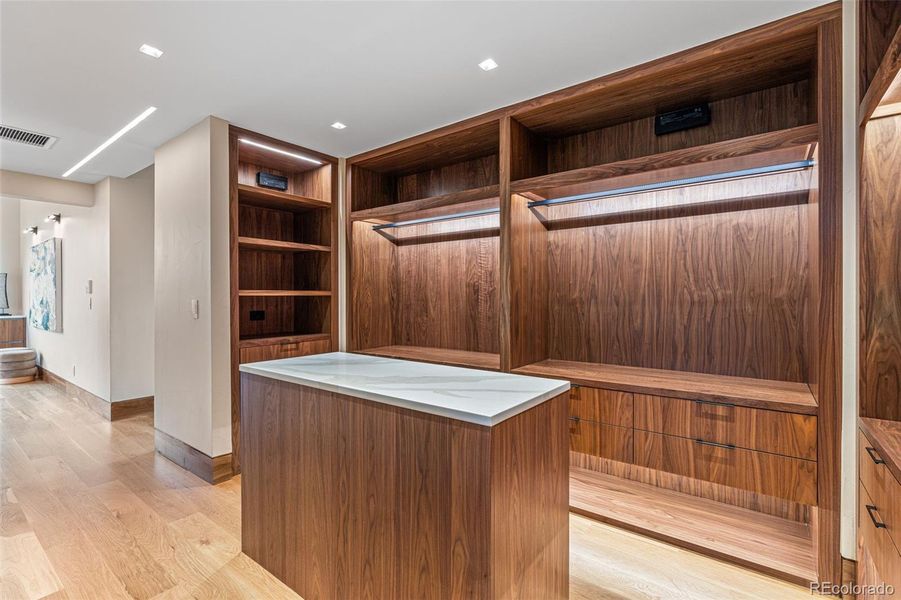 The primary closet: Quartz countertop on the central dresser island.