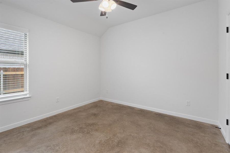 Unfurnished room featuring lofted ceiling, carpet, and ceiling fan