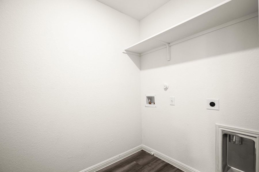 Washroom with hookup for a gas dryer, dark wood-style flooring, washer hookup, and electric dryer hookup