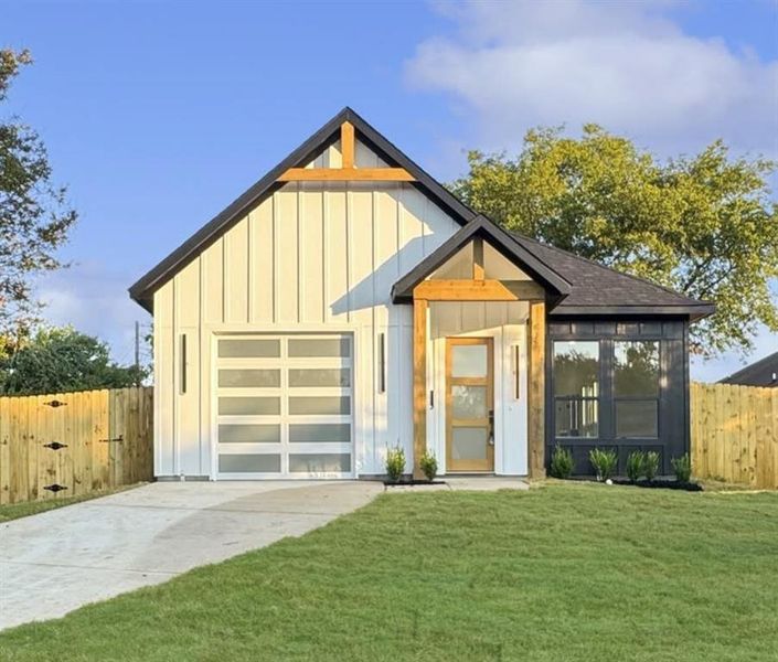 Modern farmhouse featuring board and batten siding and driveway