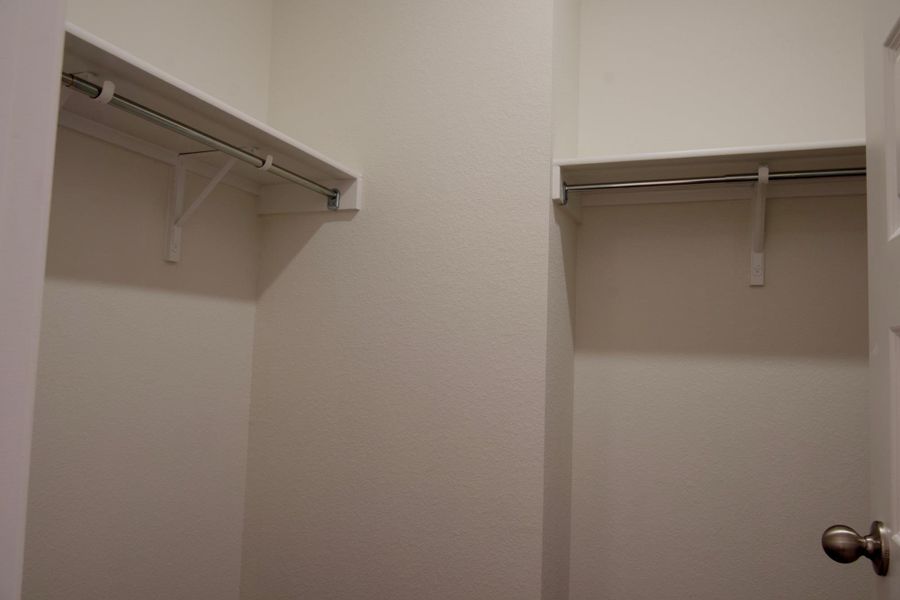 Ample shelving and hanging space offer organized storage in this well-appointed closet.