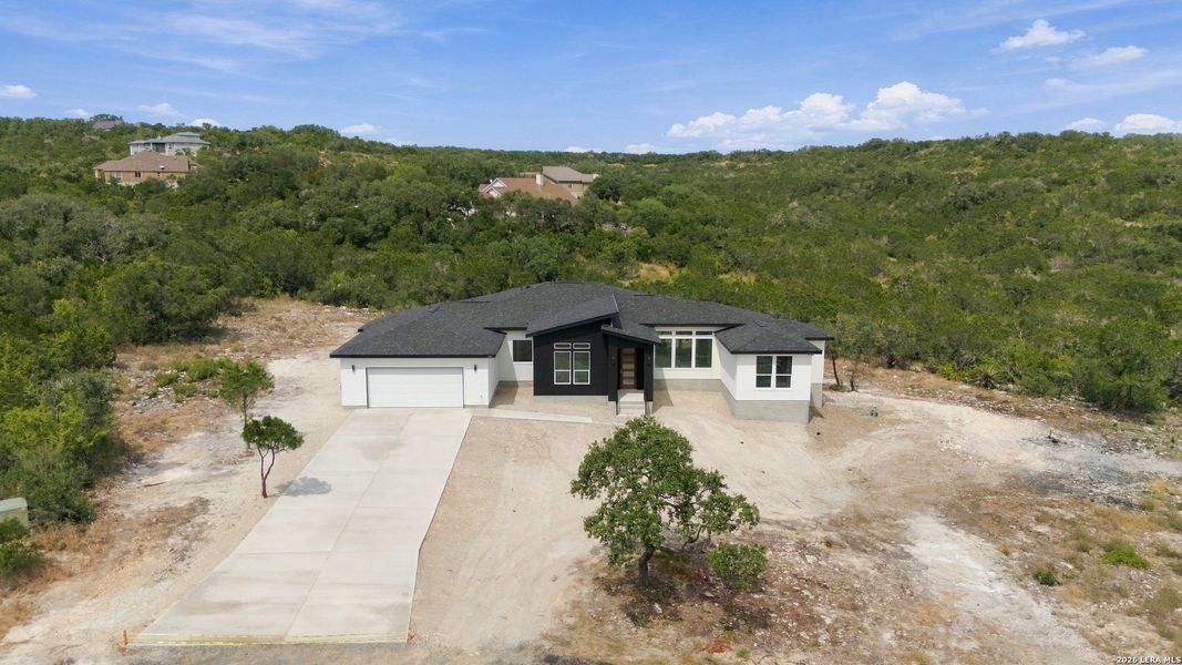 Front exterior of a new home in , Mico, TX, highlighting curb appeal (Image 26).