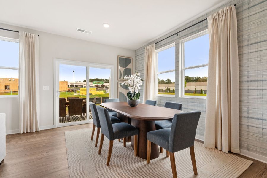 A dining room with a large window. A dining room with a large window.